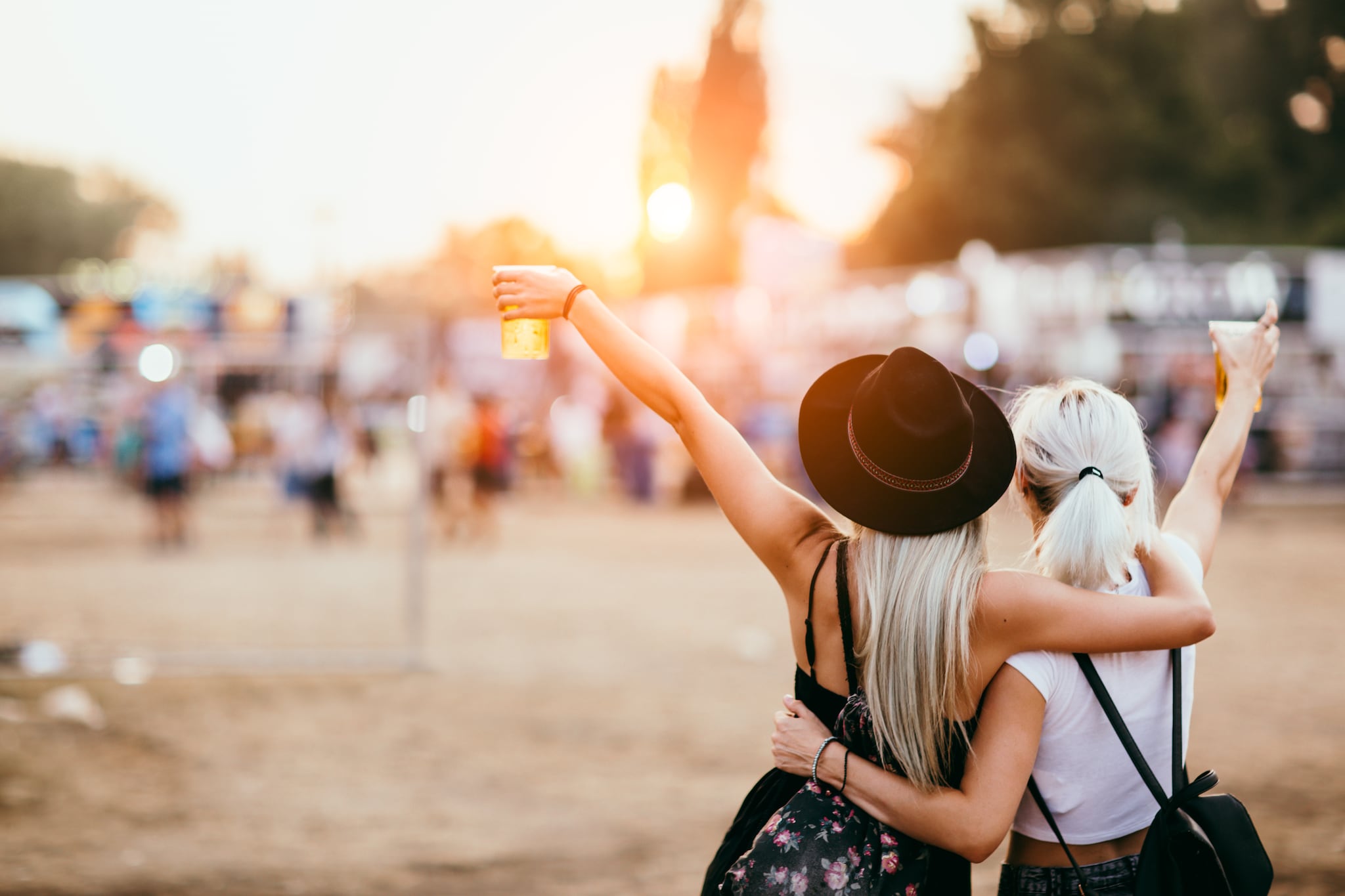 Friends drinking beer and having fun at music festival. Back view Getty Images/iStockphoto