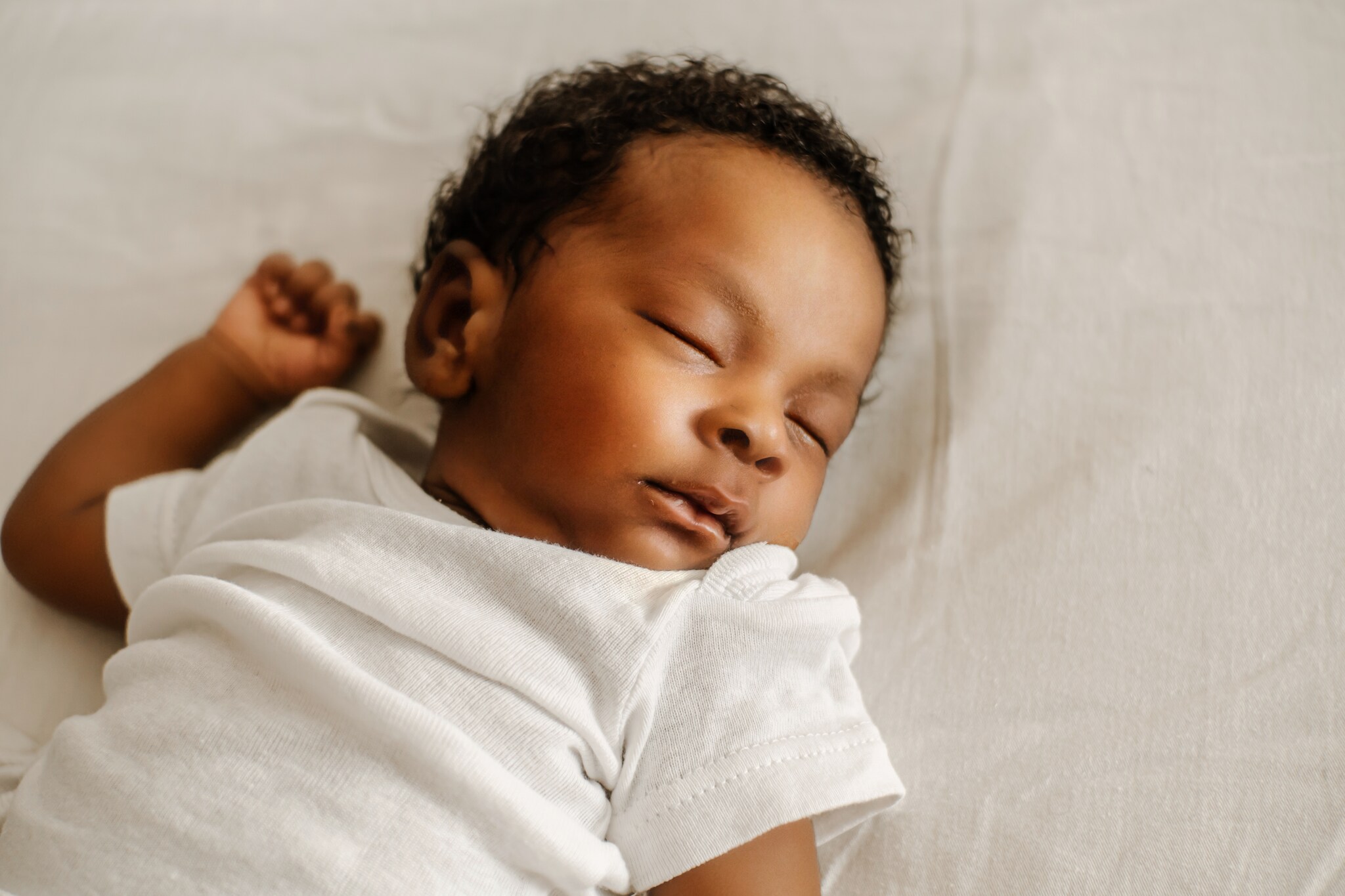 newborn sleep in the bed. Getty Images