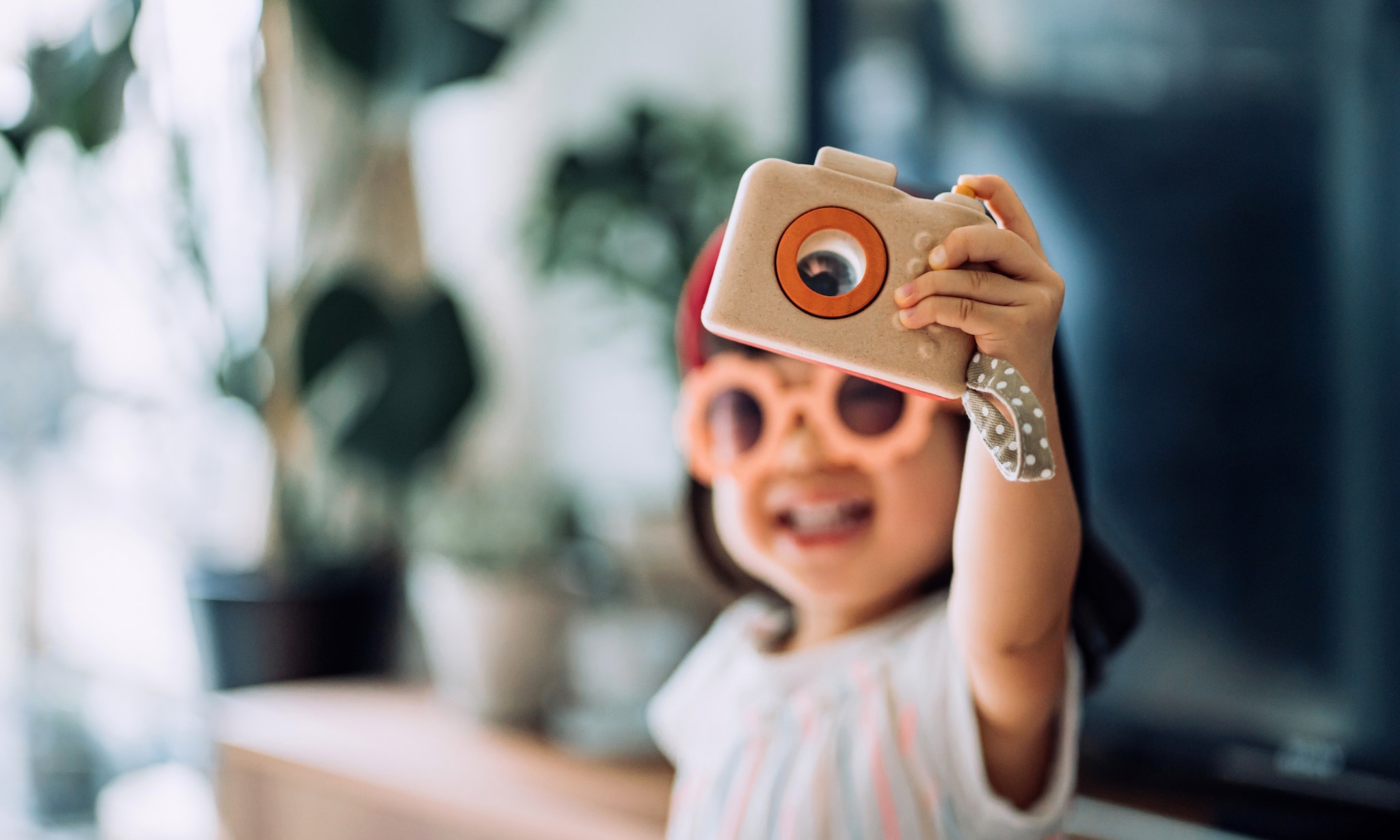 meisje speelt met kindercamera uit lijstje cadeautips voor een kind van 4 jaar Getty Images