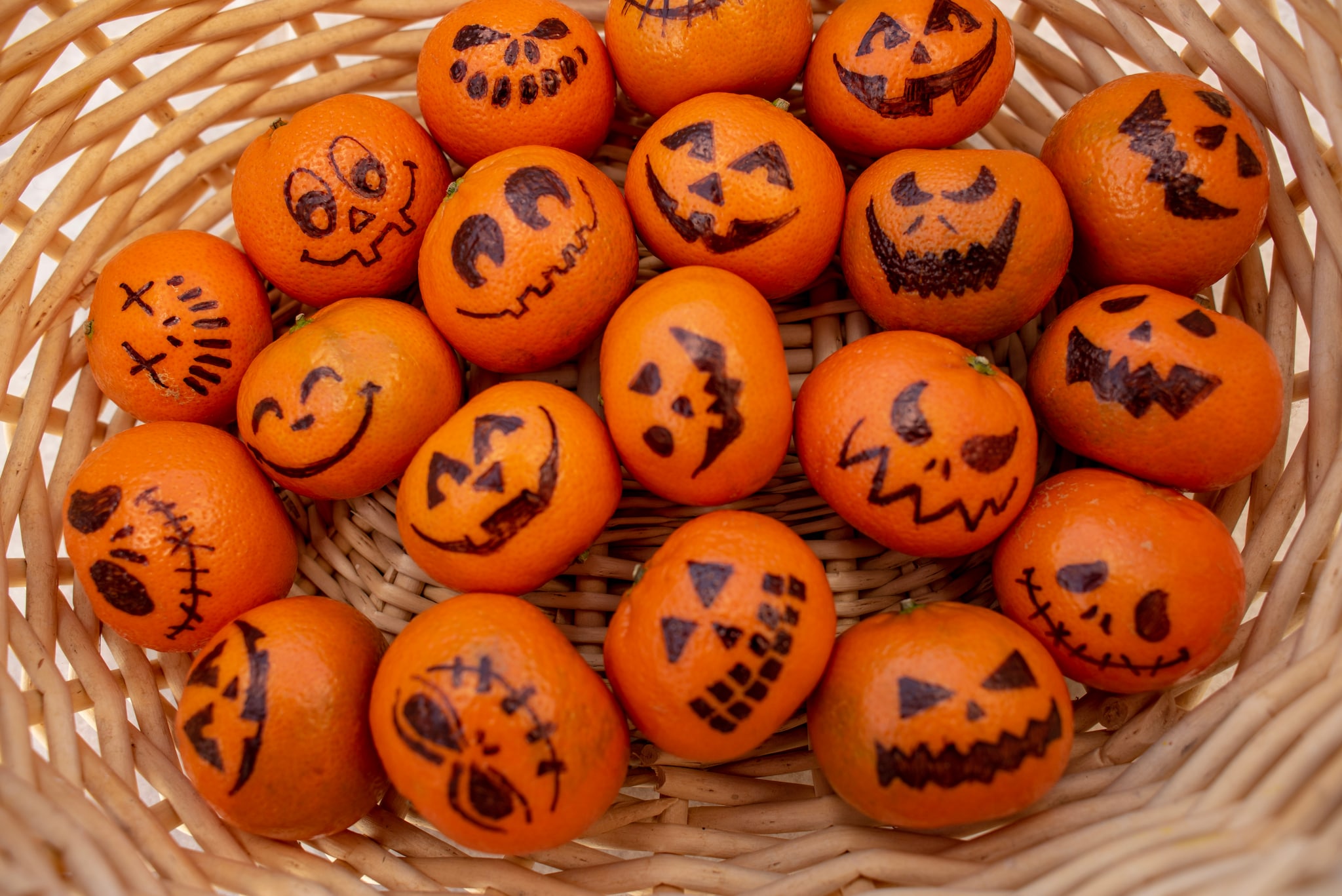 Gezonde Trick or Treat snack: mandarijntjes met enge gezichtjes, gedecoreerd met watervaste stift. Getty Images/iStockphoto
