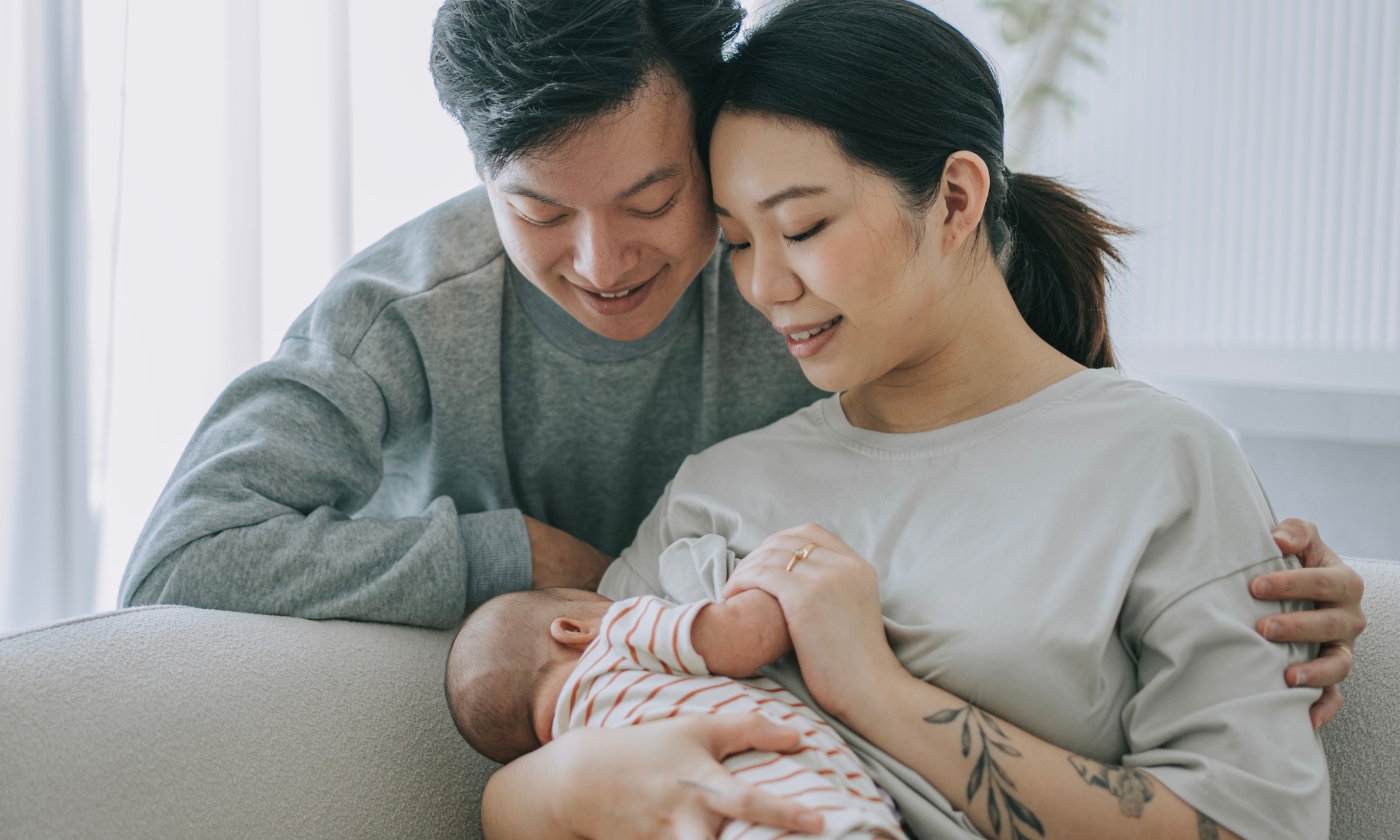 Pasgeboren baby met ouders Getty Images
