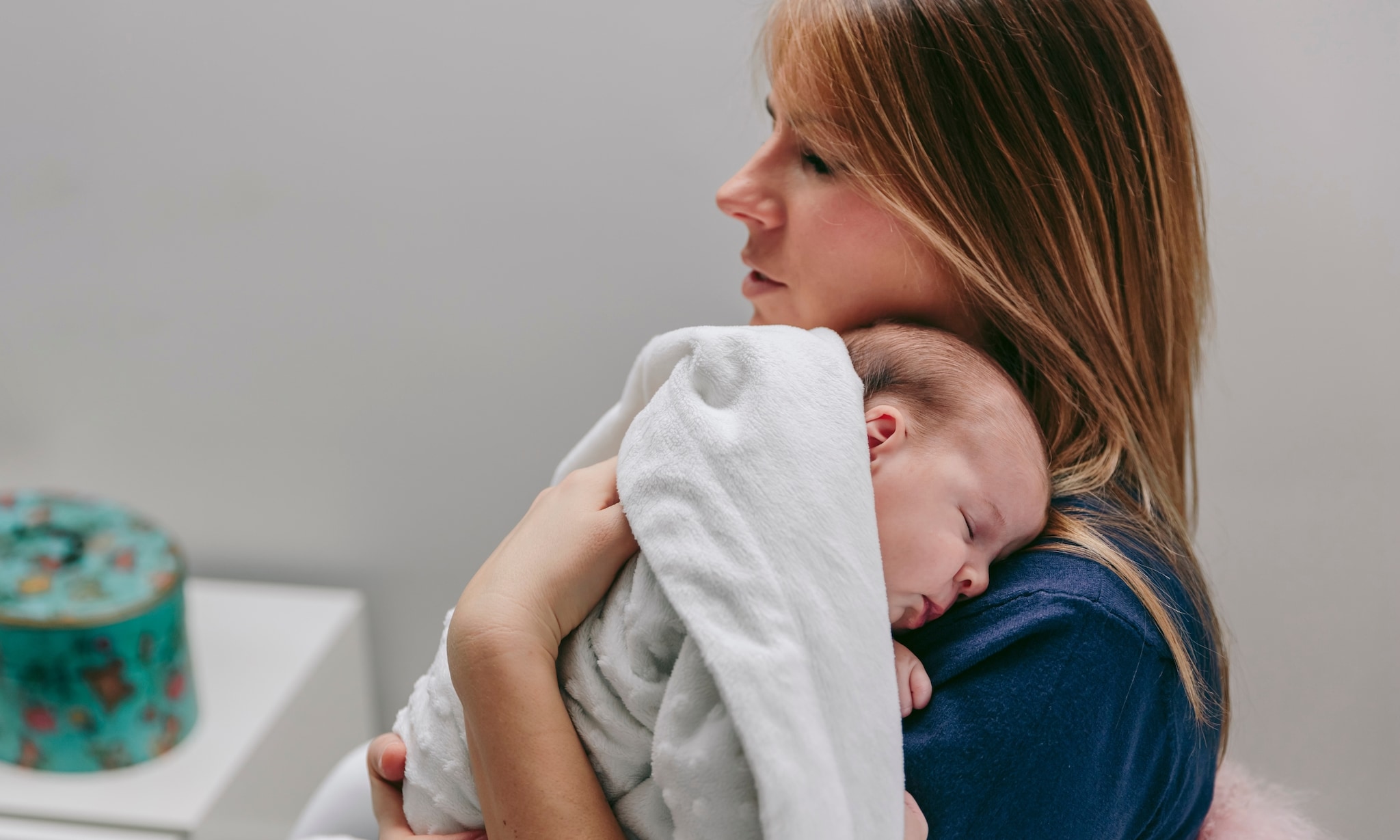 Moeder met baby op arm Getty Images