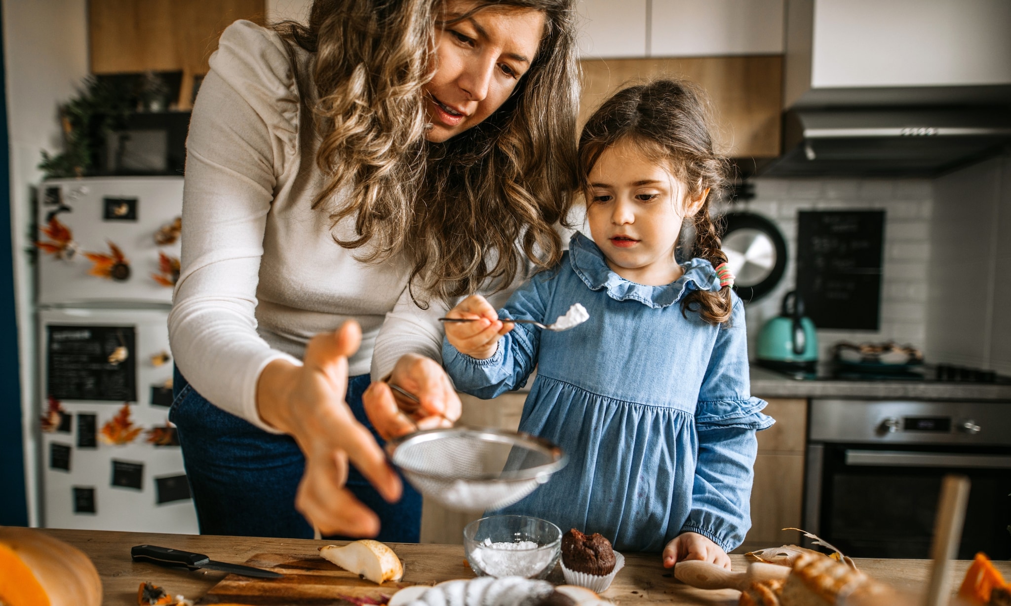 Moeder en kind maken een herfsttraktatie in de keuken Getty Images