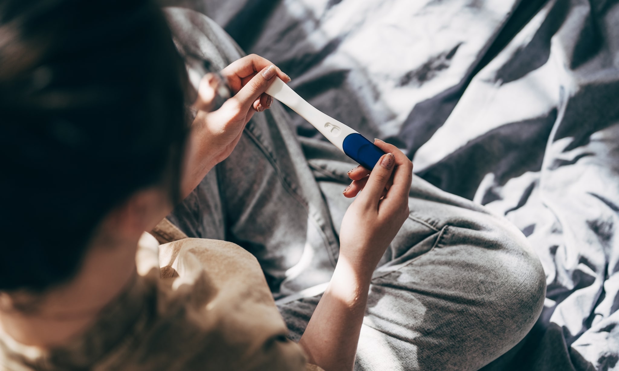 Vrouw met negatieve zwangerschapstest. Getty Images