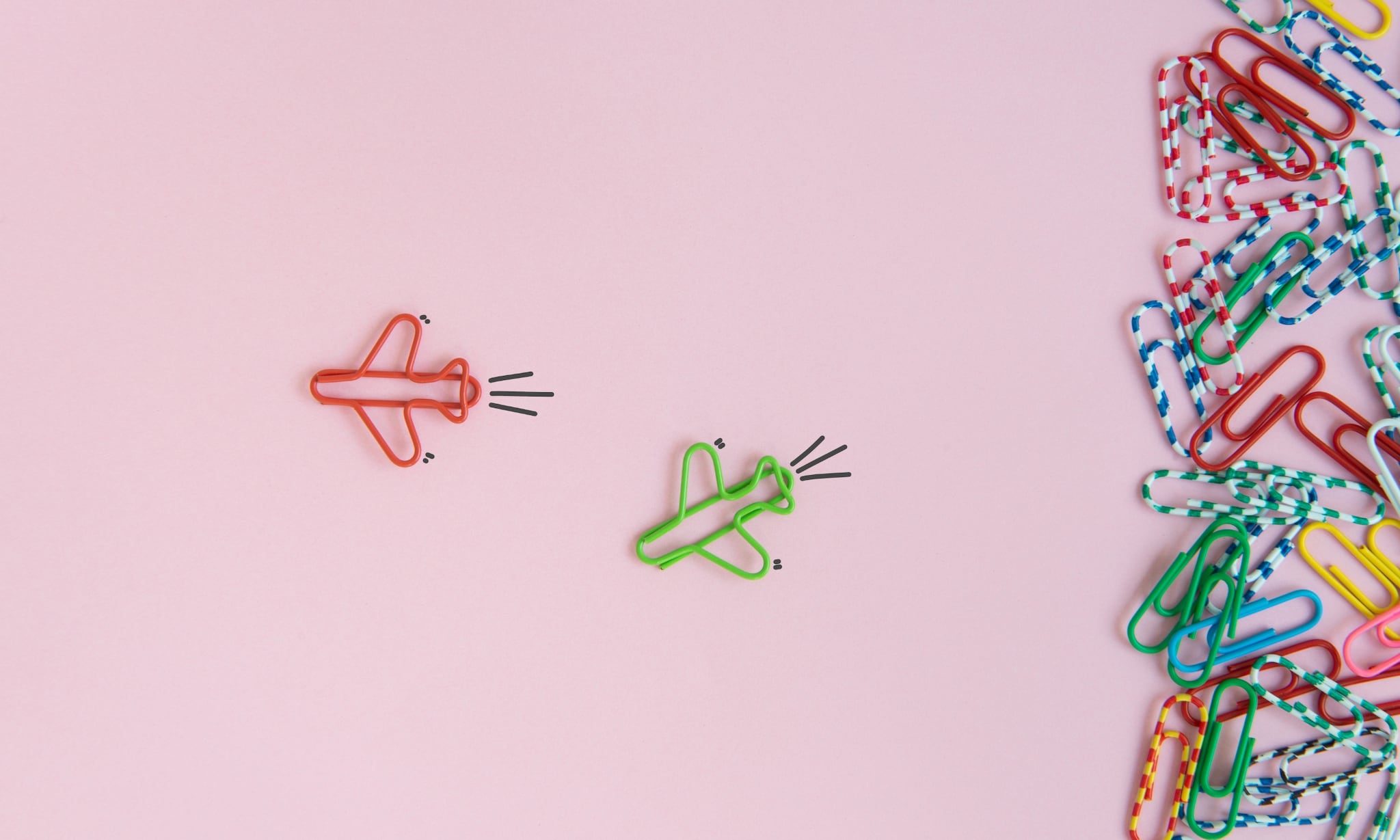 paperclips in de vorm van een vliegtuig voor roze achtergrond